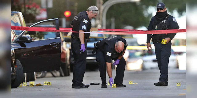 Chicago police investigate the scene of a shooting that killed rapper Carlton Weekly, known as FBG Duck, and wounded two others at 70 E. Oak St. in Chicago on August 4, 2020. (Chris Sweda/Chicago Tribune/Tribune News Service via Getty Images)