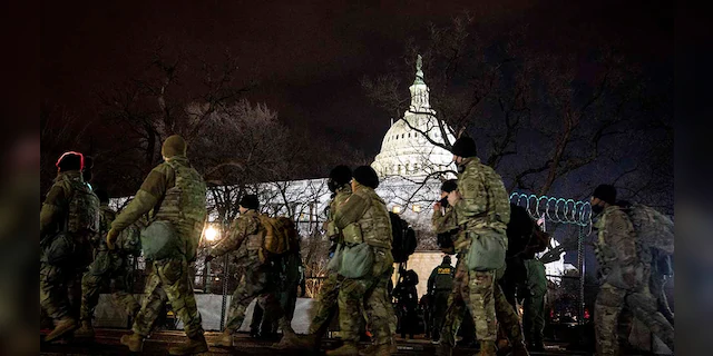National Guard stand outside the Capitol on Inauguration Day in Washington, D.C. on Wednesday, Jan. 20, 2021. (Erin Schaff/The New York Times via AP, Pool)