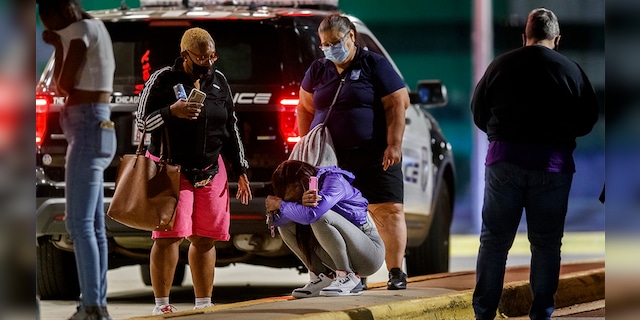 A woman kneels on the ground outside the University of Chicago Medicine's Comer Children's Hospital where a 8-year-old girl was taken after being killed in a shooting that wounded three others near the intersection of 47th street and Union Avenue during the Labor Day weekend Monday Sep. 7, 2020 in Chicago. (Armando L. Sanchez/Chicago Tribune/Tribune News Service via Getty Images)