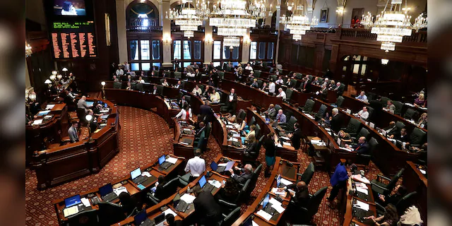 FILE: Illinois lawmakers are seen on the House floor during session at the Illinois State Capitol in Springfield Ill. 
