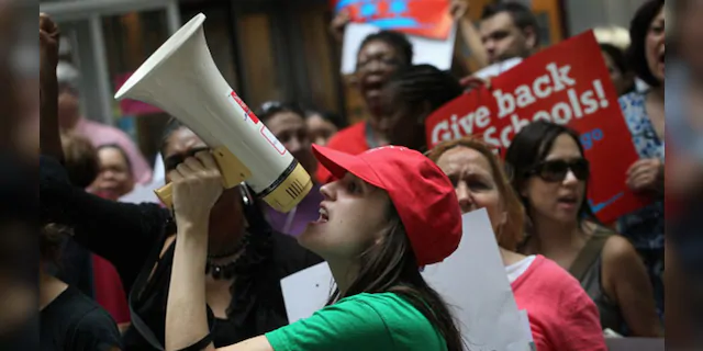 Sarah Chambers, a special education teacher, leads other Chicago school teachers in a chant during a protest June 22, 2011, in Chicago, Ill.  (Scott Olson/Getty Images)