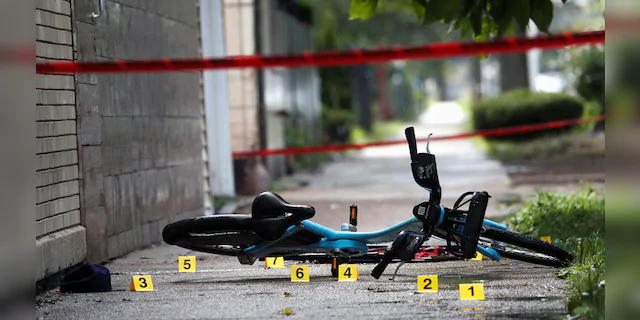 Chicago police shell casing markers are seen on July 26, 2020, where a 37-year-old man riding a bicycle was fatally shot. REUTERS/Shannon Stapleton 