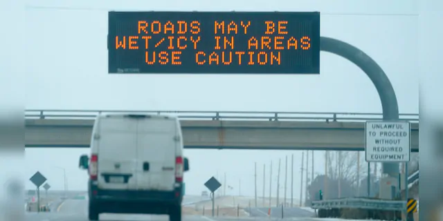An electronic road signs warns motorists headed eastbound on Interstate 70 about difficult driving conditions as a winter storm sweeps over the intermountain West on Tuesday in Aurora, Colo. (AP)