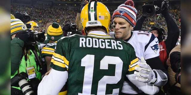 Tom Brady #12 of the New England Patriots (R) congratulates fellow quarterback Aaron Rodgers #12 of the Green Bay Packers after their game at Lambeau Field on November 30, 2014 in Green Bay, Wisconsin. The Packers defeated the Patriots 26-21. (Photo by Brian D. Kersey/Getty Images)