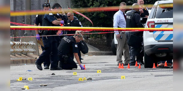 Chicago police officers investigate an officer-involved shooting outside the department's 25th district station on July 30, 2020. According to police, a prisoner was shot and and two officers were wounded. (Antonio Perez/Chicago Tribune/Tribune News Service via Getty Images)