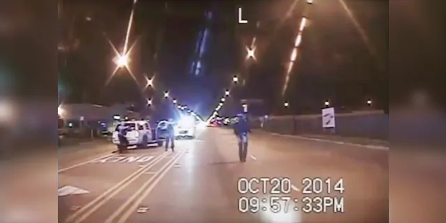 In this Oct. 20, 2014 file image taken from dash-cam video provided by the Chicago Police Department, Laquan McDonald, right, walks down the street moments before being fatally shot by Chicago Police officer Jason Van Dyke in Chicago. (Chicago Police Department via AP, File)