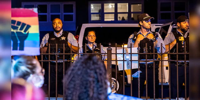 Chicago Police Department officers look on as protesters gather outside their precinct on June 19, 2020 in Chicago. (Photo by Natasha Moustache/Getty Images)