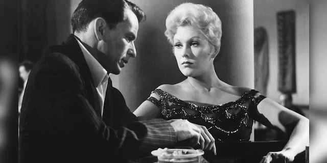 American actors Frank Sinatra and Kim Novak on the set of 'The Man with the Golden Arm,' directed by Austro–Hungarian-American Otto Preminger.