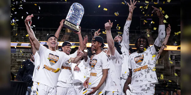 Northern Kentucky celebrates with the trophy after a 71-62 win over Illinois-Chicago in an NCAA college basketball game for the Horizon League men's tournament championship in Indianapolis, Tuesday, March 10, 2020. (AP Photo/Michael Conroy)