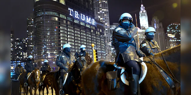 Police keep watch as a small group of demonstrators protest near Trump Tower on January 07, 2021 in Chicago, Illinois.  (Photo by Scott Olson/Getty Images)