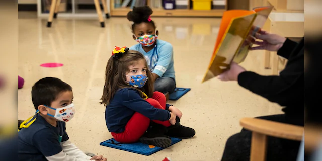Pre-kindergarten students listen as their teacher reads a story at Dawes Elementary in Chicago, on Jan. 11. (AP/Chicago Sun-Times)