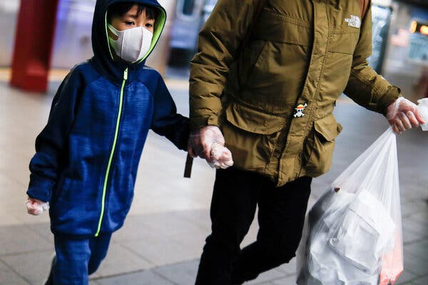 A child wore a protective mask and gloves in a New York subway station early in the pandemic. 