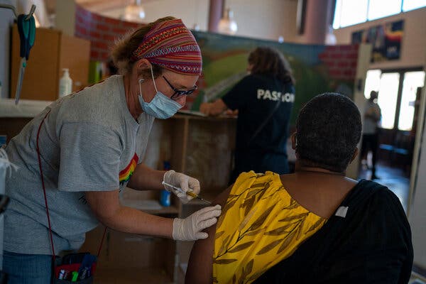 Jacqui Dallimore, a research nurse, delivering a shot to a volunteer in the Johnson &amp; Johnson vaccine trial at the Desmond Tutu H.I.V. Foundation Youth Center in Masiphumelele, South Africa, in December.