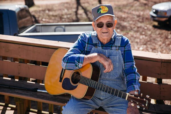 Alvie Dooms, who plays rhythm guitar, at his home in rural Ava, Mo., last month.