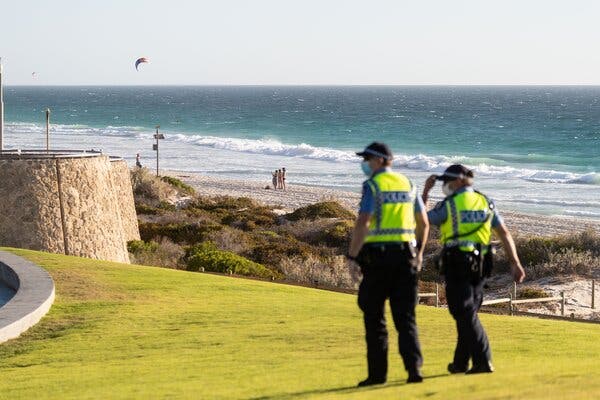 Police officers patrolling Scarborough Beach near Perth, Australia, on Sunday after officials announced a lockdown for the region.