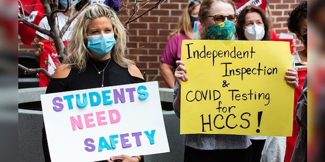 Teachers and PSC CUNY union members hold signs during a strike outside Hunter Campus High School in New York, U.S., on Wednesday, Sept. 16, 2020. Photographer: Paul Frangipane/Bloomberg via Getty Images