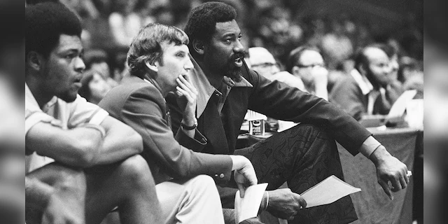 Wilt Chamberlain, right, coach of the San Diego Conquistadors, and assistant coach Stan Albeck, center, watch in the opening minutes of the team's basketball game against the New York Nets in 1974. (Associated Press)