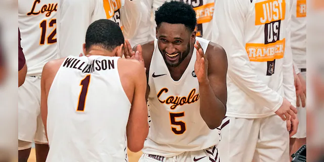 Loyola of Chicago's Keith Clemons (5) and teammate Lucas Williamson (1) celebrate following a 75-65 victory over Drake in the championship game of the NCAA Missouri Valley Conference men's basketball tournament Sunday, March 7, 2021, in St. Louis. (AP Photo/Jeff Roberson)