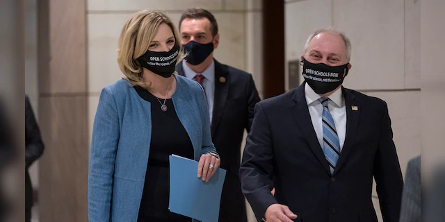 Rep. Ashley Hinson, R-Iowa, and Rep. Steve Scalise, R-La., the House minority whip, right arrive to talk to reporters, following a GOP strategy session, at the Capitol in Washington, Tuesday, March 9, 2021. 