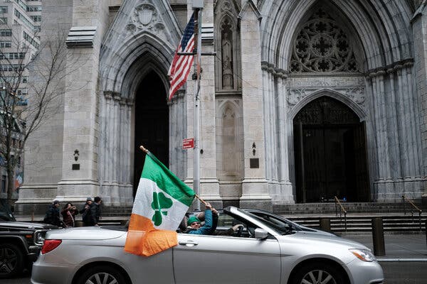 People waved a flag in celebration of St. Patrick’s Day last year, despite the cancellation of the parade in New York because of the pandemic. Celebrations around the country will again be cancelled this year.