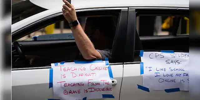 Chicago Teachers Union members and supporters join a car caravan outside Chicago Public Schools headquarters while a Chicago Board of Education meeting takes place inside in Chicago on July 22, 2020. (Photo by Max Herman/NurPhoto via Getty Images)
