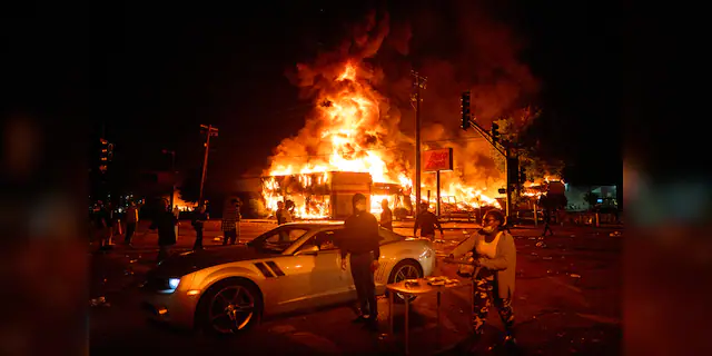 An AutoZone store burns as protesters gather outside of the Third Precinct in Minneapolis Thursday, May 28, 2020. (Mark Vancleave/Star Tribune via AP)