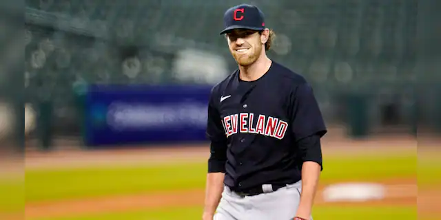 Shane Bieber has reported to training camp with the Cleveland Indians after recovering from COVID-19. The right-hander took part in drills on Saturday, Feb. 20, 2021, a day before the Indians hold their first full-squad workout in Goodyear, Ariz. (AP Photo/Paul Sancya, File)
