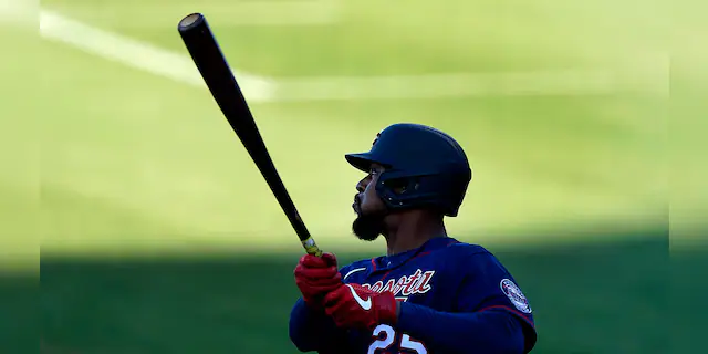 Minnesota Twins' Byron Buxton follows through on a three-run double during the first inning of the team's spring training baseball game against the Boston Red Sox on Thursday, March 25, 2021, in Fort Myers, Fla. (AP Photo/John Bazemore)