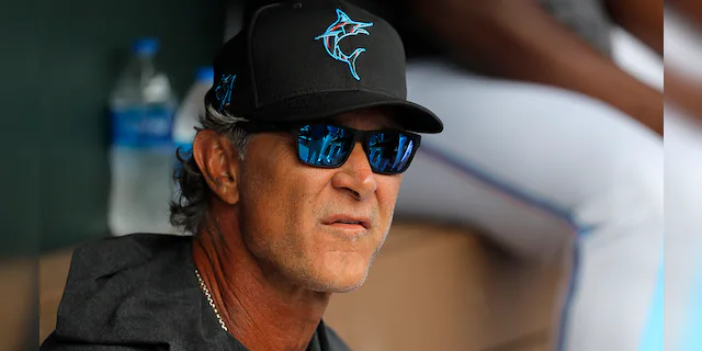 Miami Marlins manager Don Mattingly looks on from the dugout prior to a spring training baseball game against the Washington Nationals in Jupiter, Fla., in this Tuesday, March 10, 2020, photo. (AP Photo/Julio Cortez, File)