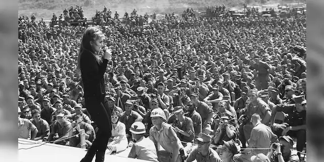 Thousands of service personnel listen to Ann-Margret sing one of her numbers during a show in Vietnam, circa 1966.
