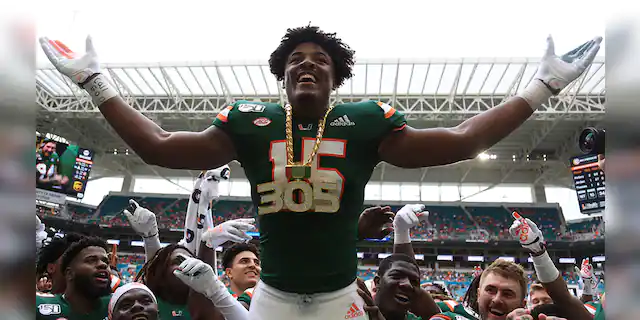 Miami Hurricanes defensive lineman Gregory Rousseau (15) celebrates wearing the turnover chain during the first quarter of a football game against the Central Michigan Chippewas at Hard Rock Stadium.