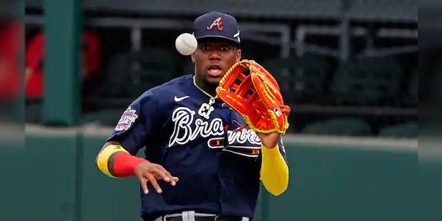 Atlanta Braves right fielder Ronald Acuna Jr. fields a ball hit for a single by Boston Red Sox' Marwin Gonzalez in the fifth inning of a spring training baseball game on Monday, March 29, 2021, in North Port, Fla. Acuna threw to third and caught J.D. Martinez trying to advance. (AP Photo/John Bazemore)