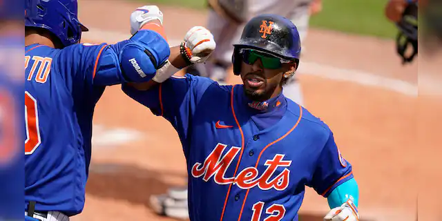 New York Mets' Francisco Lindor (12) is congratulated by Michael Conforto after scoring on a solo home run during the fifth inning of a spring training baseball game Miami Marlins, Tuesday, March 23, 2021, in Port St. Lucie, Fla. (AP Photo/Lynne Sladky)