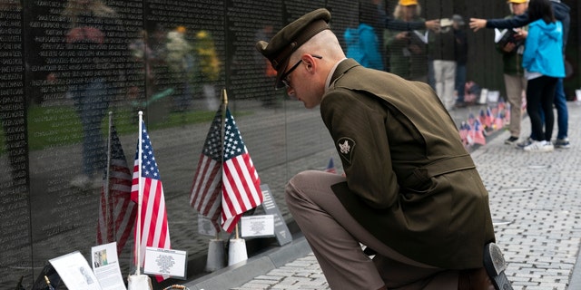 Army Spc. Joseph Wolfe reads the names of the fallen soldiers at Vietnam Veterans Memorial at the National Mall ahead of Memorial Day, in Washington, Sunday, May 30, 2021. (AP Photo/Jose Luis Magana)