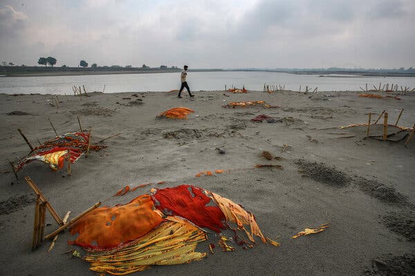 Bodies, some of which are believed to be Covid-19 victims, partly exposed in shallow sand graves on the banks of the Ganges River last week in Uttar Pradesh, India.