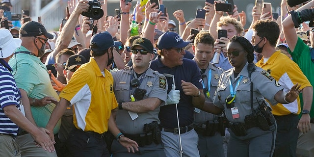 Phil Mickelson tries to get through the crowd during the final round at the PGA Championship golf tournament on the Ocean Course, Sunday, May 23, 2021, in Kiawah Island, S.C. (AP Photo/Matt York)