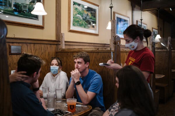 University of Missouri students ordering in a restaurant last week. Masks will no longer be required indoors for the vaccinated.