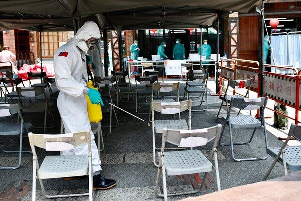 Disinfecting seats at a Covid-19 testing site in Taipei on Saturday.