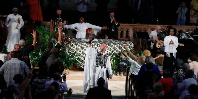 Rev. Michael Pfleger conducts his first Sunday church service as a senior pastor at St. Sabina Catholic Church following his reinstatement by Archdiocese of Chicago after decades-old sexual abuse allegations against minors, Sunday, June 6, 2021, in the Auburn Gresham neighborhood in Chicago. (AP Photo/Shafkat Anowar)
