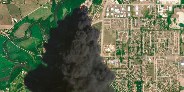 In this Satellite image provided by Planet Labs Inc., a huge plume of smoke and fires can be seen at the Chemtool Inc. plant near Rockton, Illinois, on Monday. A private firefighting company from Louisiana was expected to begin pumping fire-suppressing foam Tuesday onto the still-burning ruins of a northern Illinois chemical plant, a day after it was rocked by an explosion and massive fires, officials said. (Planet Labs Inc. via AP)