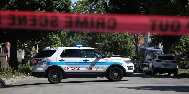 Police tape marks off a Chicago street as officers investigate the scene of a fatal shooting in the city's South Side on Tuesday, June 15, 2021. An argument in a house erupted into gunfire early Tuesday, police said. (Associated Press)
