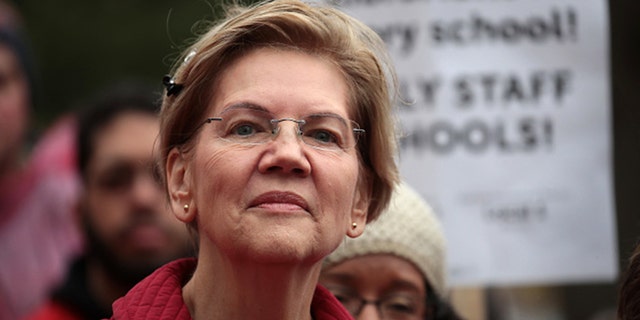 Democratic presidential candidate Sen. Elizabeth Warren (D-Mass.) visits with striking Chicago teachers at Oscar DePriest Elementary School on October 22, 2019, in Chicago, Illinois. Warren said she won't back any bipartisan infrastructure bill without an "ironclad" commitment on a larger human infrastructure bill. (Photo by Scott Olson/Getty Images)