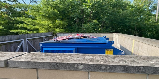 Other flags from the display, which is set to remain through the Fourth of July holiday, were placed on top of a dumpster near the facility. (Courtesy VFW Post &amp; Auxiliary #1138)