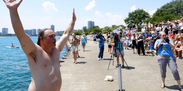 Dan O'Conor, the "Great Lake Jumper," reacts after making his 365th leap into Lake Michigan, Saturday, June 12, 2021, in Chicago's Montrose Point. 