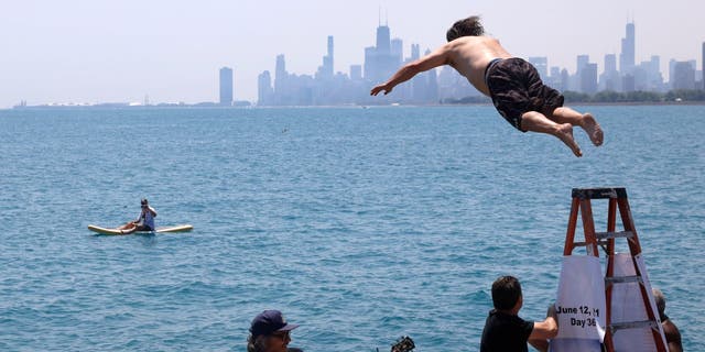 Dan O'Conor, the "Great Lake Jumper," makes his 365th leap into Lake Michigan, Saturday, June 12, 2021, in Chicago's Montrose Point.