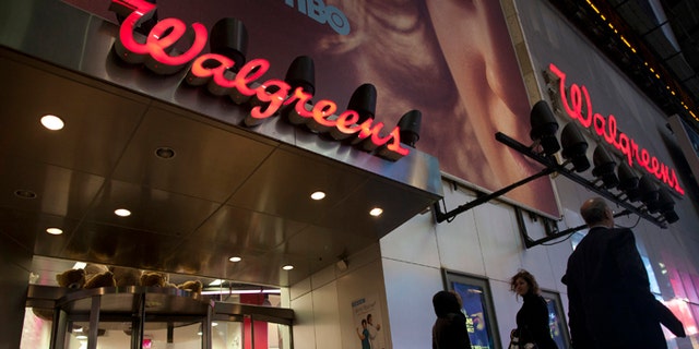 Shoppers walk by at the Walgreens' Times Square store in New York December 17, 2012. REUTERS/Andrew Kelly (UNITED STATES - Tags: BUSINESS) - RTR3BP1R
