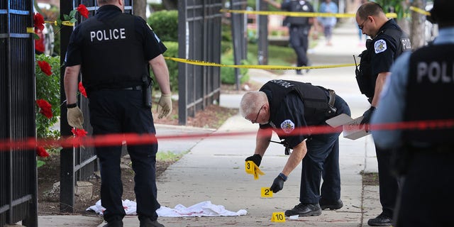Police investigate a crime scene where three people were shot at the Wentworth Gardens housing complex in the Bridgeport neighborhood on June 23, 2021 in Chicago, Illinois. A 24-year-old man died from injuries he suffered in the shooting and two others, a 22-year-old male and a 25-year-old male, were seriously wounded. 