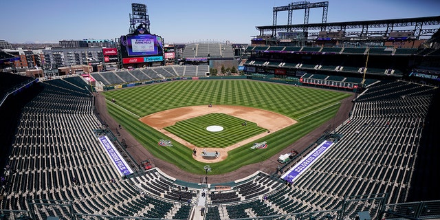 Workers prepare Coors Field on Wednesday, March 31, 2021, in Denver, the day before the Colorado Rockies' season-opener against the Los Angeles Dodgers. (Associated Press)