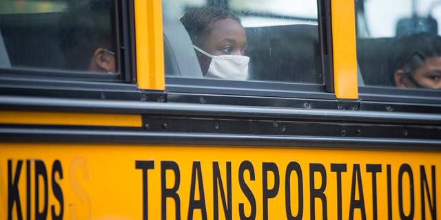 FILE - In this Oct. 12, 2020, file photo, students arrive by bus at Foundation Preparatory School for their return to school in New Orleans.  (Chris Granger/The Times-Picayune/The New Orleans Advocate via AP, File)