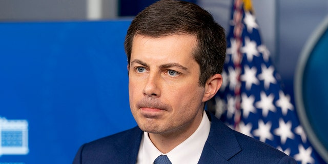 Transportation Secretary Pete Buttigieg takes a question from a reporter at a press briefing at the White House, Friday, April 9, 2021, in Washington.